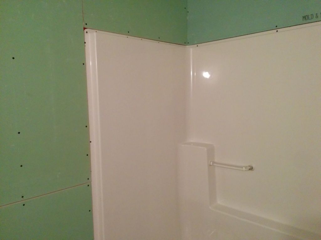 Best approach to tile over this shower flange?